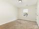 Simple bedroom featuring neutral carpet, a window with blinds, and a closet at 1623 Forest Stream Ct, Charlotte, NC 28213