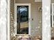 Close up of the front door with glass and sidelights, and decorative door hardware at 1623 Forest Stream Ct, Charlotte, NC 28213