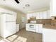 Functional kitchen with white appliances, tile flooring and ample cabinet space at 1623 Forest Stream Ct, Charlotte, NC 28213
