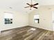 Bright living room featuring new flooring, windows with blinds, and a ceiling fan at 1623 Forest Stream Ct, Charlotte, NC 28213