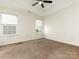 Bright main bedroom featuring neutral walls, carpet, and a ceiling fan at 1623 Forest Stream Ct, Charlotte, NC 28213