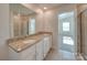 Well-lit bathroom with double sinks, granite countertops, and a glass-enclosed shower at 4342 Allenby Pl, Monroe, NC 28110