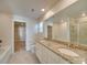 Bright bathroom with granite countertops, double sinks, and a large mirror at 4342 Allenby Pl, Monroe, NC 28110
