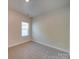 A bright bedroom featuring neutral walls, carpet flooring, and a window at 4342 Allenby Pl, Monroe, NC 28110