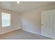 Bright bedroom with neutral carpet, a window, and two white doors at 4342 Allenby Pl, Monroe, NC 28110