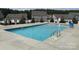 A pristine community pool with clear blue water, surrounded by a concrete deck and fencing at 4342 Allenby Pl, Monroe, NC 28110