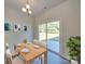 Bright dining area with wood table, four chairs, and a sliding glass door to the outdoor patio at 4342 Allenby Pl, Monroe, NC 28110