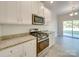 Bright kitchen features stainless steel appliances, white cabinetry, and granite countertops at 4342 Allenby Pl, Monroe, NC 28110