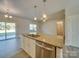 Kitchen island with granite countertops, sink, and stainless-steel dishwasher in an open-concept design at 4342 Allenby Pl, Monroe, NC 28110