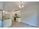 Open-concept kitchen with stainless steel appliances, granite countertops, and white cabinetry at 4342 Allenby Pl, Monroe, NC 28110