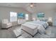 A bright main bedroom featuring carpet flooring, a bed, and two pictures on the wall at 4342 Allenby Pl, Monroe, NC 28110