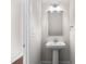 Small bathroom with pedestal sink, mirror, and light fixture at 8603 Mcclure Cir, Charlotte, NC 28216