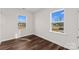 Well-lit bedroom featuring hardwood floors and ample natural light at 8603 Mcclure Cir, Charlotte, NC 28216