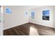 Bright bedroom with hardwood floors and multiple windows at 8603 Mcclure Cir, Charlotte, NC 28216
