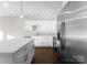 White kitchen with stainless steel appliances and an island at 8603 Mcclure Cir, Charlotte, NC 28216