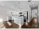 Open concept kitchen with island and stainless steel appliances at 8603 Mcclure Cir, Charlotte, NC 28216