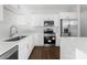 Modern kitchen with white cabinets, stainless steel appliances, and island at 8603 Mcclure Cir, Charlotte, NC 28216