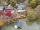 Aerial view of a home with a pool, lakefront dock, and colorful fall foliage at 271 Lockhard Cir, Troutman, NC 28166