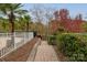Backyard with stairs leading down to a fenced pool area and lake access at 271 Lockhard Cir, Troutman, NC 28166