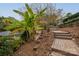 Backyard steps lead to a lakeside area with lush landscaping, enhancing outdoor appeal at 271 Lockhard Cir, Troutman, NC 28166