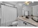 Classic white bathroom with marble countertop, framed mirror, and shower with white curtain at 271 Lockhard Cir, Troutman, NC 28166