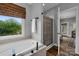 Stylish bathroom features soaking tub, shower, and natural light, creating a spa-like ambiance at 271 Lockhard Cir, Troutman, NC 28166