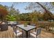 Outdoor deck with stylish patio furniture overlooks lush foliage and lake access at 271 Lockhard Cir, Troutman, NC 28166