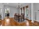 Elegant dining room features hardwood floors, neutral paint, chandelier, and large windows with natural light at 271 Lockhard Cir, Troutman, NC 28166