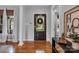 Inviting entryway with hardwood floors, decorative front door, and views into the living space at 271 Lockhard Cir, Troutman, NC 28166