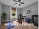 Virtually staged exercise room includes a ceiling fan, an exercise bike, yoga mat, and dumbbells for a complete workout at 271 Lockhard Cir, Troutman, NC 28166