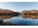 Picturesque lake view with calm waters, vibrant fall foliage, and serene reflections of the landscape at 271 Lockhard Cir, Troutman, NC 28166