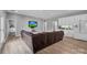 Inviting living room with a large television, leather sectional, and adjoining mini-bar with white cabinets at 271 Lockhard Cir, Troutman, NC 28166