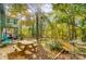 Lush backyard with a wooden picnic table and chairs, providing a tranquil outdoor setting at 11429 Spreading Oak Ln, Charlotte, NC 28226