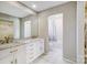Bright bathroom featuring a marble countertop vanity with double sinks and a separate toilet and tub at 11429 Spreading Oak Ln, Charlotte, NC 28226
