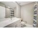 A modern bathroom is showcased with a vanity, toilet, and tub-shower combo with decorative tile and shower curtain at 11429 Spreading Oak Ln, Charlotte, NC 28226