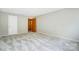 A spacious bedroom has neutral walls and carpet with a door leading to a bathroom at 11429 Spreading Oak Ln, Charlotte, NC 28226