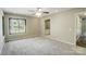 Neutral bedroom has plush carpet and views to an ensuite bath at 11429 Spreading Oak Ln, Charlotte, NC 28226