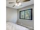 Comfortable bedroom featuring a window view, ceiling fan, and carpeted floors, creating a serene atmosphere at 11429 Spreading Oak Ln, Charlotte, NC 28226