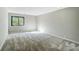 A well-lit bedroom with carpet and a window providing natural light at 11429 Spreading Oak Ln, Charlotte, NC 28226