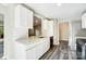 Modern kitchen boasts white cabinets, quartz countertops, and stainless steel appliances for a sleek look at 11429 Spreading Oak Ln, Charlotte, NC 28226