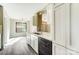 Updated kitchen featuring quartz countertops, white cabinets, and views to adjacent dining and living spaces at 11429 Spreading Oak Ln, Charlotte, NC 28226