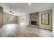 Spacious living room featuring a stone fireplace and modern wood-look flooring at 11429 Spreading Oak Ln, Charlotte, NC 28226