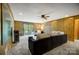 Spacious living room featuring wood paneling, a large sofa, carpeted floors, and sliding glass doors at 11429 Spreading Oak Ln, Charlotte, NC 28226
