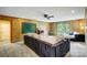 Expansive living room with wood-paneled walls, large sofa, and sliding glass doors to an outdoor area at 11429 Spreading Oak Ln, Charlotte, NC 28226