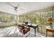 Bright sun room featuring a ceiling fan, carpeted floors, and large windows with a view of the trees at 11429 Spreading Oak Ln, Charlotte, NC 28226