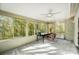 Bright sunroom with wall-to-wall windows offering scenic backyard views at 11429 Spreading Oak Ln, Charlotte, NC 28226