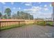 Large wooden deck overlooking a grassy yard and wooded area at 117 Jentri Way, Mooresville, NC 28115