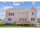 Rear view showing a home with a wooden deck, a large, flat yard, and several windows at 117 Jentri Way, Mooresville, NC 28115