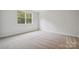 Bright and spacious bedroom with neutral colored carpet and large window at 117 Jentri Way, Mooresville, NC 28115