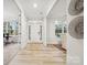 Light-filled entryway with a white door and wood-look flooring at 117 Jentri Way, Mooresville, NC 28115